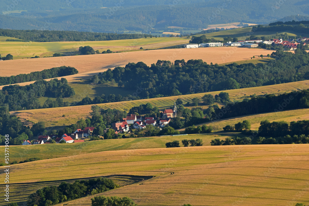 landscape in the thuringian Eichsfeld with view to the village Rustungen