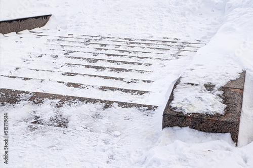Winter. Stairs. Danger of accident on snow-covered slippery steps