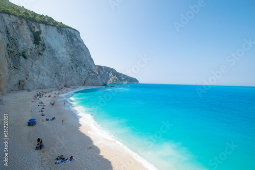 View of Porto Katsiki beach under the cliffs next to exotix turquoise sea with people at the beach at Lefkada island in Greece photo