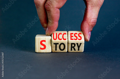 Success story symbol. Concept words Success story on wooden cubes. Businessman hand. Beautiful grey table grey background. Business and Success story concept. Copy space.