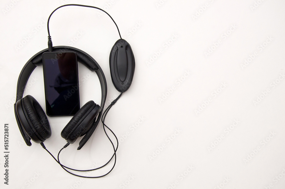 Headphones and smartphone on white background Headphones and smartphone on white background