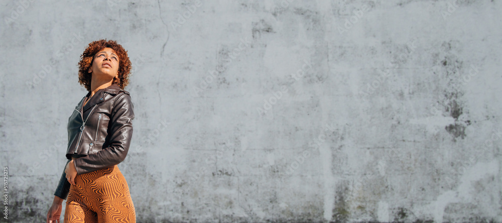 urban latin american girl with wall in background urban latin american girl with wall in background