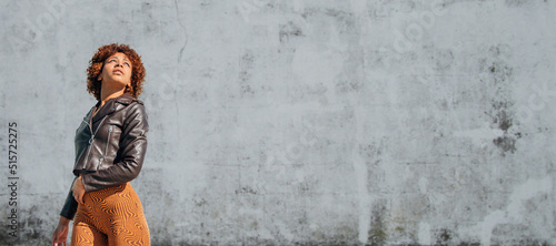 urban latin american girl with wall in background