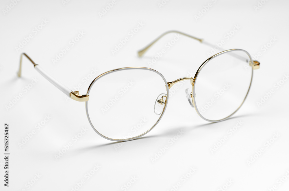 Stylish eyeglasses on a white background. Iron frame glasses Stylish eyeglasses on a white background. Iron frame glasses