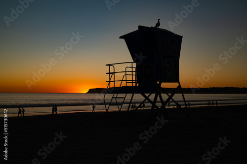 A lifeguard stand in silhouette at sunset on Coronado Beach, San Diego, California.