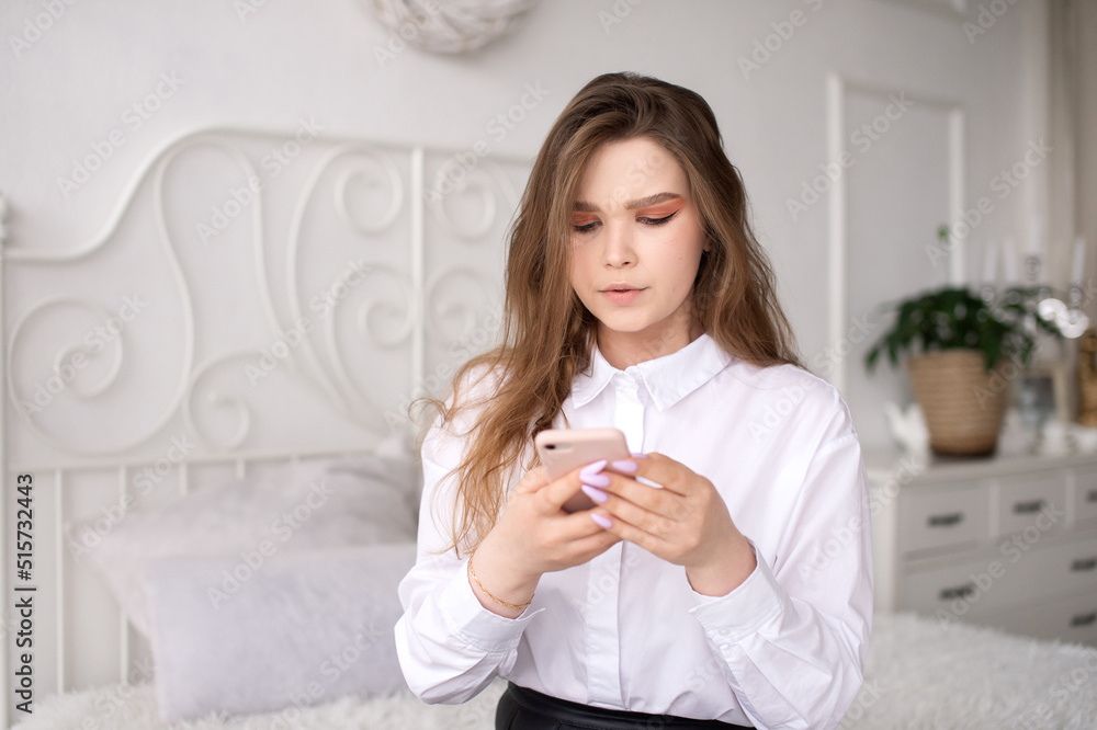 A young business woman reads the news or sends a text message. Surprised A young business woman reads the news or sends a text message. Surprised