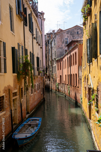 boat in water near buildings (canal in venice)