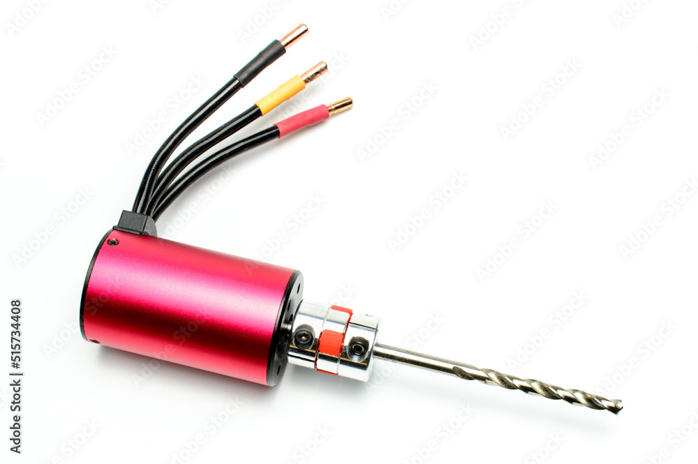 Electric micro drill for drilling of printed circuit boards (PCB). Small drilling machine. Three phase brushless red motor with cables. Selective focus. Isolated on white background. Electric micro drill for drilling of printed circuit boards (PCB). Small drilling machine. Three phase brushless red motor with cables. Selective focus. Isolated on white background.