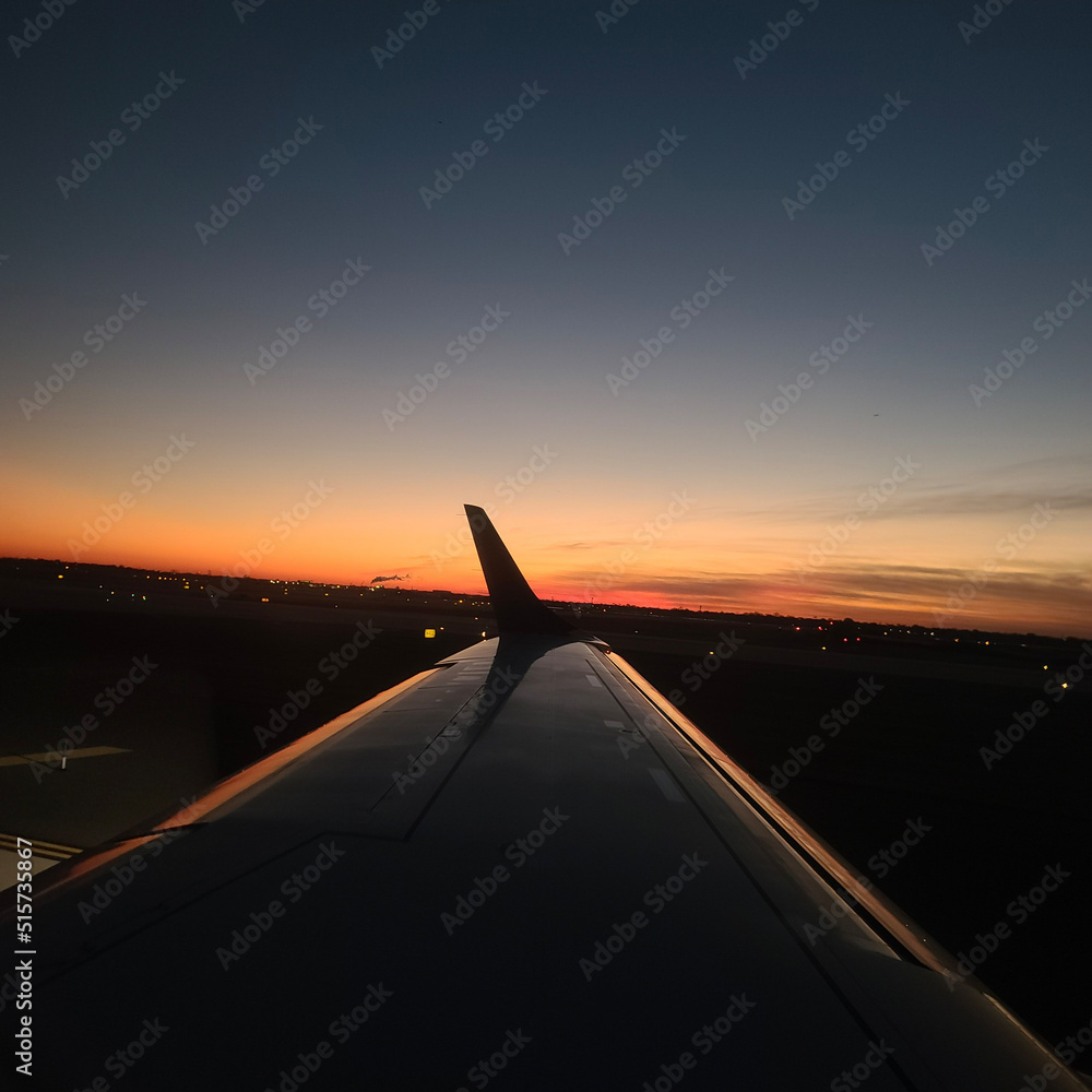 Fototapeta premium airplane landing at sunset