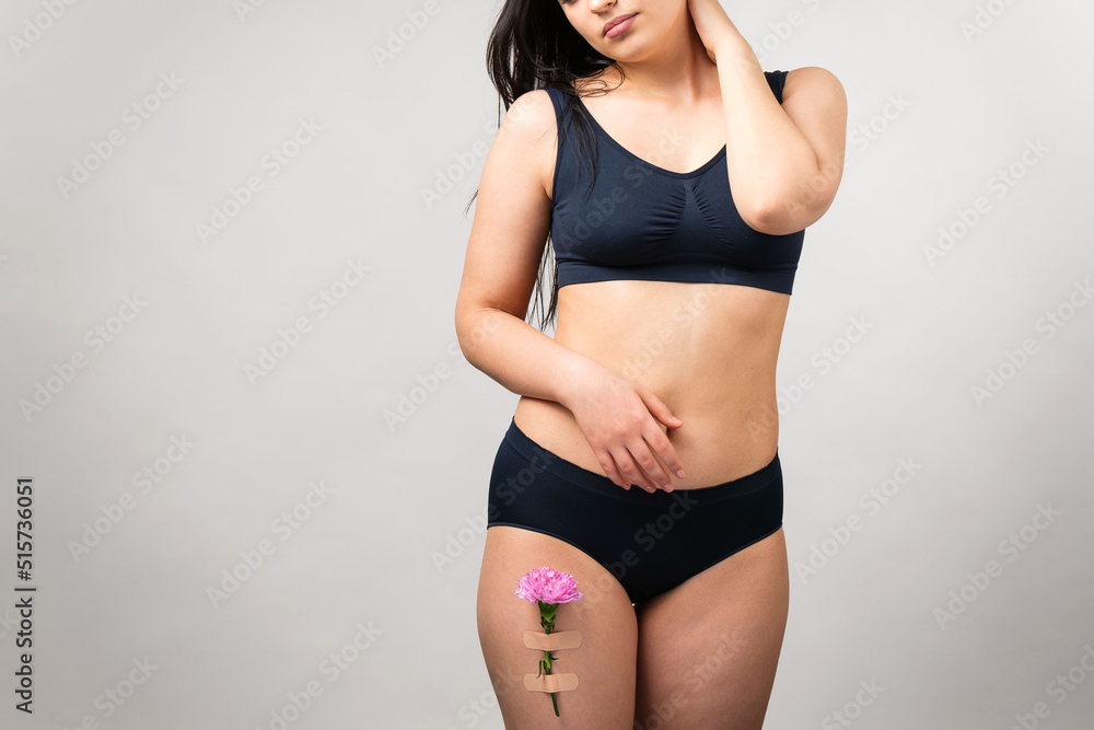 Cropped photo of a brunette woman wearing black lingerie set touching her neck with her hand and another hand keeping on the stomach. Cropped photo of a brunette woman wearing black lingerie set touching her neck with her hand and another hand keeping on the stomach.