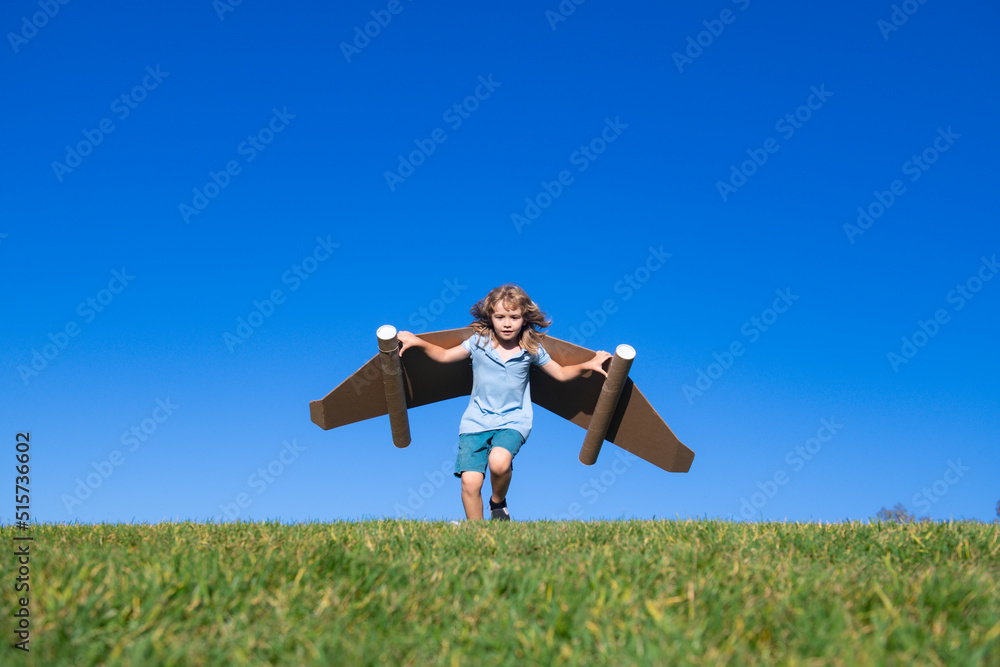 Little child plays astronaut or pilot. Child on the background of blue sky. Kids with paper wings jetpack dreams. Children imagines dreams of flying. Funny kid with toy jet pack. Success, imagination. Little child plays astronaut or pilot. Child on the background of blue sky. Kids with paper wings jetpack dreams. Children imagines dreams of flying. Funny kid with toy jet pack. Success, imagination.