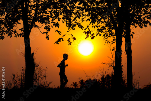 Silhouette of jogging man on sunset background, Jogging in the sunset.