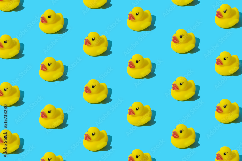 Yellow rubber toy duck on a blue background. Pattern. Yellow rubber toy duck on a blue background. Pattern.