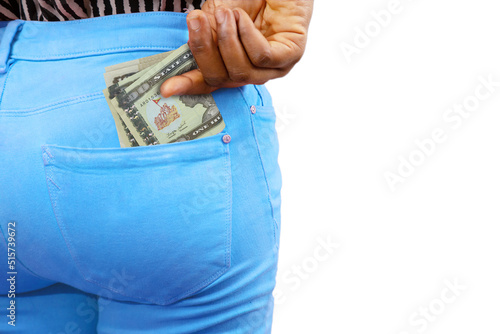 Black lady putting few 100 Eritrean nakfa notes into her back pocket. Removing money from pocket, hold money