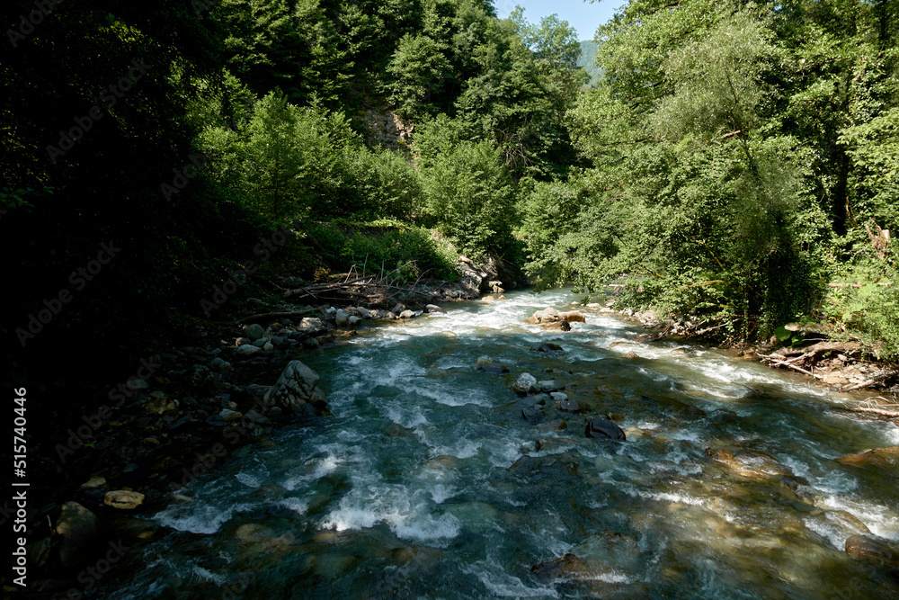 Small waterfalls going over rocks in Caucasian State Natural Biosphere Reserve, a clear-water mountain stream in the Lago-Naki plateau, Russia. Small waterfalls going over rocks in Caucasian State Natural Biosphere Reserve, a clear-water mountain stream in the Lago-Naki plateau, Russia.