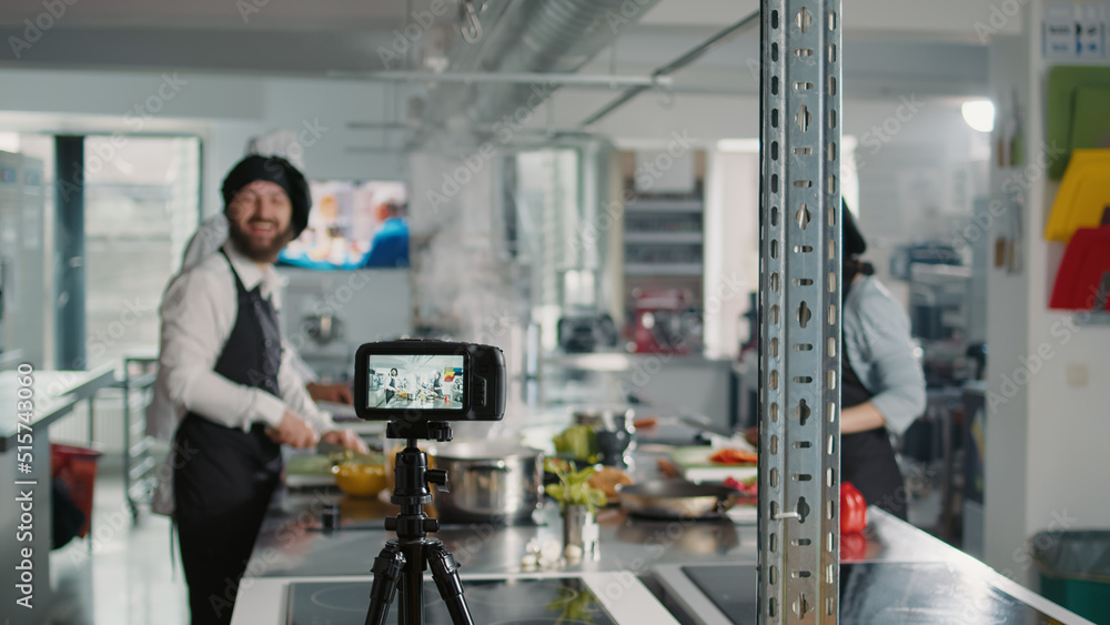 Professional camera recording cooking show content with chefs in restaurant kitchen, filming people making food recipe dish with fresh ingredients. Gastronomy cuisine online class. Professional camera recording cooking show content with chefs in restaurant kitchen, filming people making food recipe dish with fresh ingredients. Gastronomy cuisine online class.