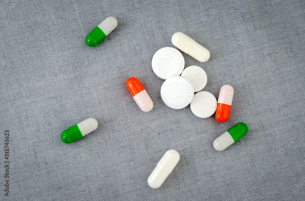 Medication: capsules and pills on a gray background. Medical concept. Close-up Medication: capsules and pills on a gray background. Medical concept. Close-up