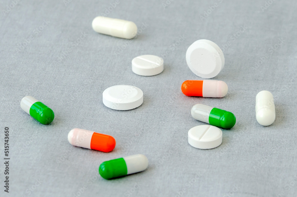 Medication: capsules and pills on a gray background. Medical concept. Close-up Medication: capsules and pills on a gray background. Medical concept. Close-up