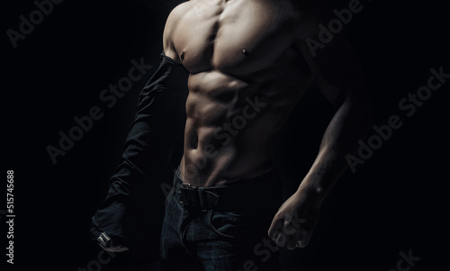 Muscular body. Sexy young man with perfect muscular body. Sports and bodybuilding. Abs, six pack. Mens beauty and health. Strong healthy handsome athletic chest of muscular man, close up.