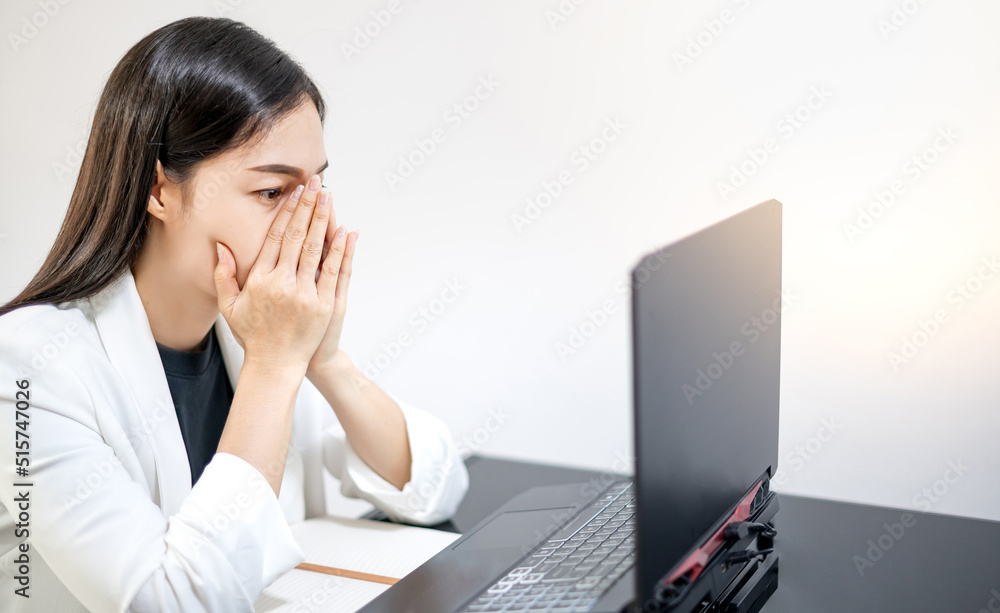 Asian young feeling stress from work, while sitting in front of the laptop in their home. Asian young feeling stress from work, while sitting in front of the laptop in their home.