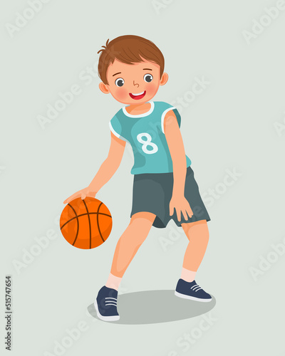 cute little boy with sportswear playing basketball dribbling the ball in action