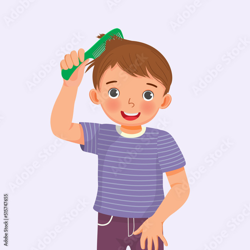 cute little boy holding comb enjoying combing his hair 