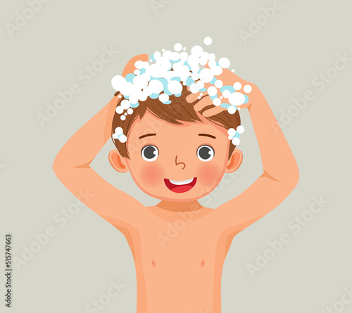 Cute little boy washing his hair with shampoo in the bathroom