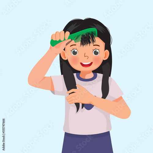 cute little girl holding comb enjoying combing her long hair 