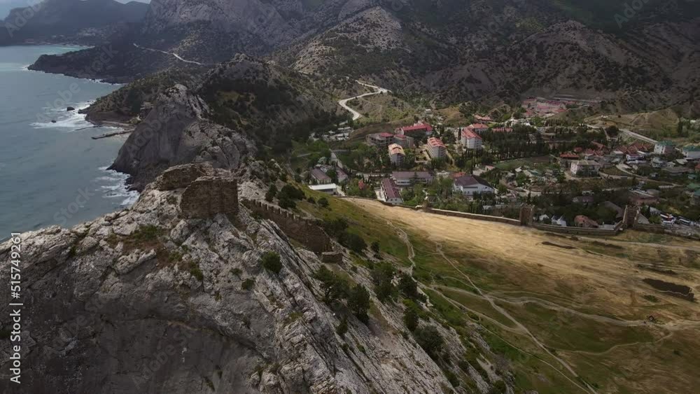 Beautiful ruins of the Sudak fortress and Mount Fortress on the Black Sea coast. Panoramic view from a drone in 4k. Crimean peninsula. Beautiful ruins of the Sudak fortress and Mount Fortress on the Black Sea coast. Panoramic view from a drone in 4k. Crimean peninsula.