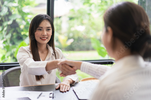 Coworker business concept, Two businesswoman shake hands after successfully discussing the project