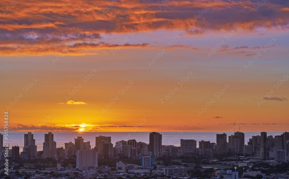 A fiery red sunset cityscape and beach with sunset sky in evening. Birds eye view of a city and colorful sky with clouds at night background with summer sunrise and wonderful view of an urban town