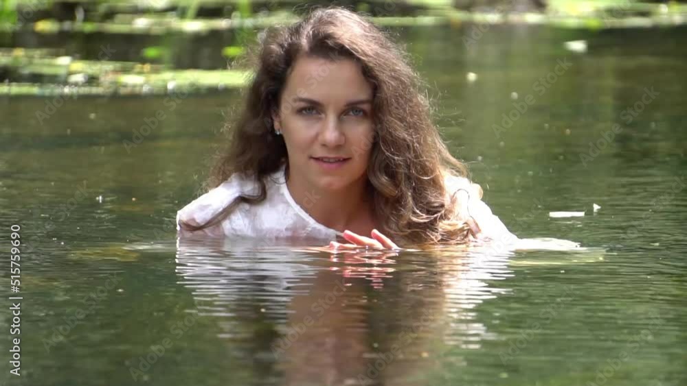 A sexy girl in a white dress position in the river A sexy girl in a white dress position in the river