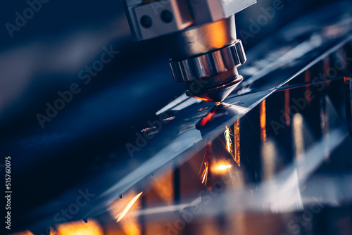 Closeup Laser CNC cut of metal with light spark Blue color. Concept technology industrial