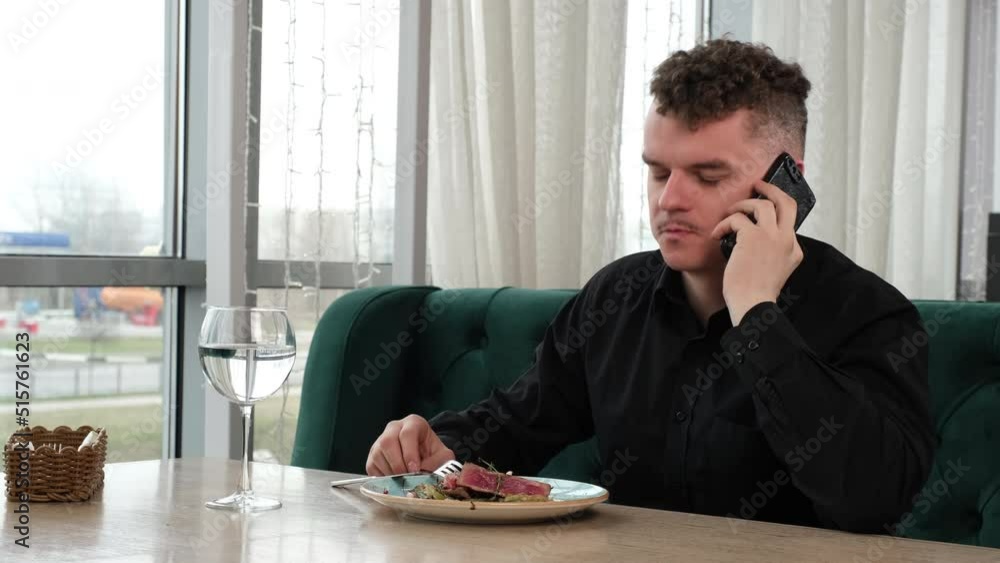 The guy is talking on the phone during a business lunch The guy is talking on the phone during a business lunch