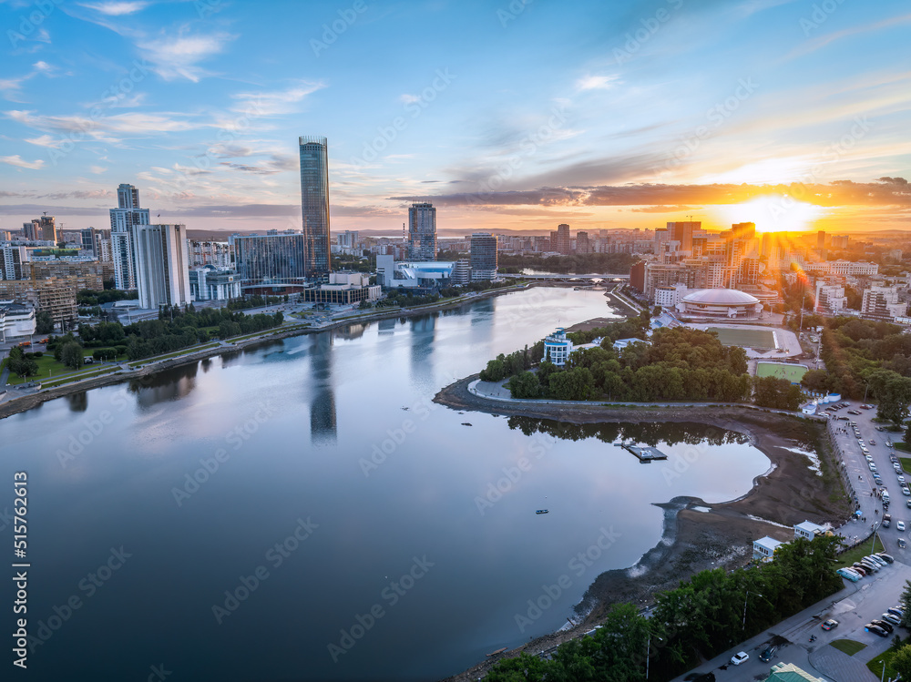Fototapeta premium Yekaterinburg city and pond aerial panoramic view at summer sunset.