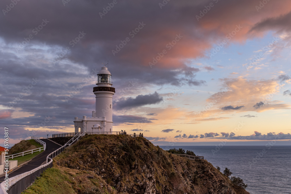 a wide shot at sunrise of the historic lighthouse at cape byron at byron bay