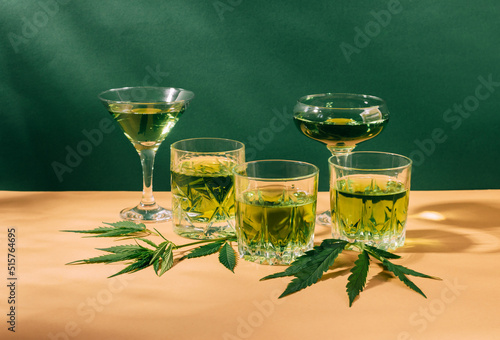 Hemp green drink SBD, creative green hard shadow background. Rest energy relaxing cannabis cocktail. photo