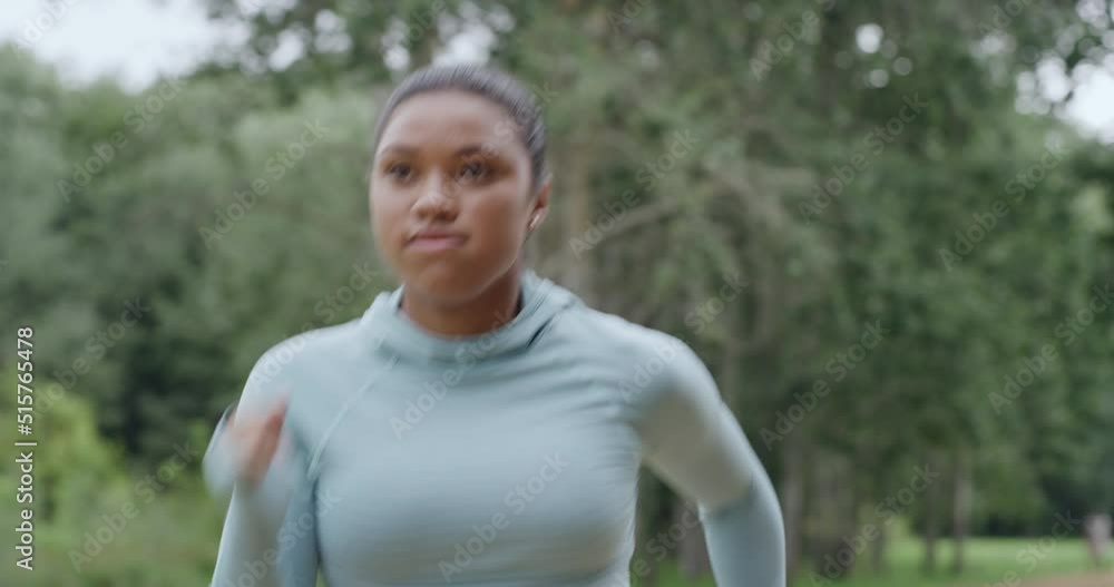 Active young woman running and jogging in a park outside from below. One focused and determined athlete doing cardio exercise while training for a marathon. Runner leading a fit and healthy lifestyle Active young woman running and jogging in a park outside from below. One focused and determined athlete doing cardio exercise while training for a marathon. Runner leading a fit and healthy lifestyle