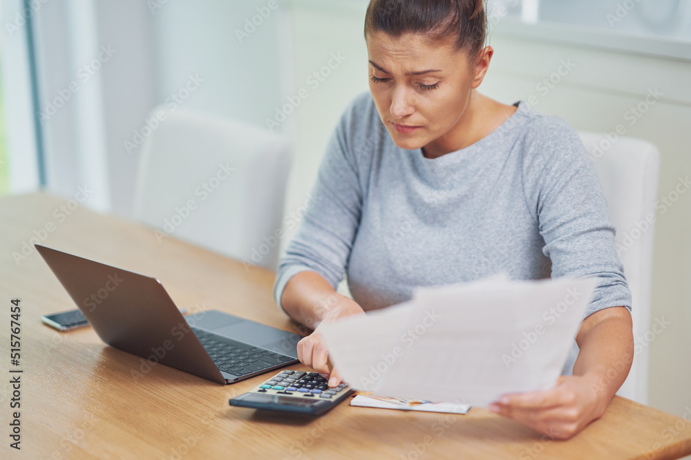 Young woman counting home budget with bills Young woman counting home budget with bills