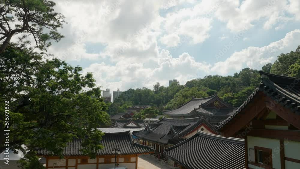 Day timelapse over Bongeunsa Temple buildings with fluffy soft clouds movement in summer Day timelapse over Bongeunsa Temple buildings with fluffy soft clouds movement in summer