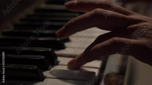 Close up of the hands of a young woman playing piano