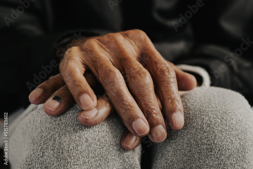 Valokuvatapetti Close up of male wrinkled hands, old man is wearing vintage tone.