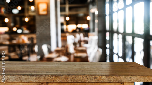 Empty dark wooden table in front of abstract blurred bokeh background of restaurant . can be used for display or montage your products. © Nuttapong punna