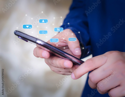 Person using smartphone checking various online notifications social media icon. Social media used in daily life and digital online concept.