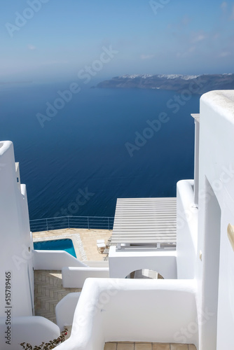 A beautiful terrace with sunbeds, swimming pool and a breathtaking view over the Aegean Sea in Santorini Greece