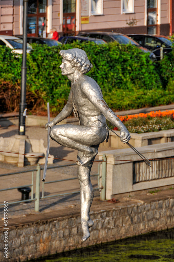 Naklejka premium Passing through the river - a sculpture suspended on a rope by the Brda River. Bydgoszcz, Kuyavian-Pomeranian Voivodeship, Poland.