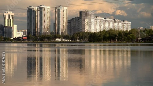 General view of the big city (Minsk), which is reflected in a large pond photo