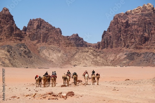 Bedouins with camels on Wadi Rum Desert in Jordan. The amazing Wadi Rum desert with Martian scenery.