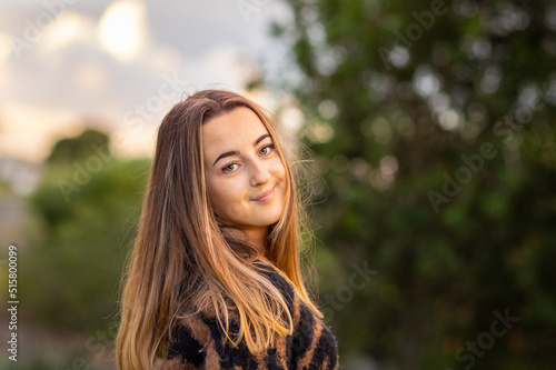 teenage girl looking sweetly ay the camera over her shoulder