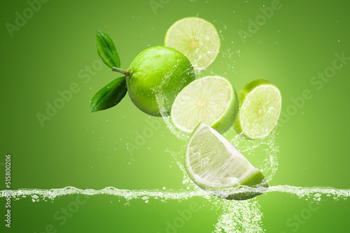lemonade Splashing on Green lemon fruit isolated on Green background